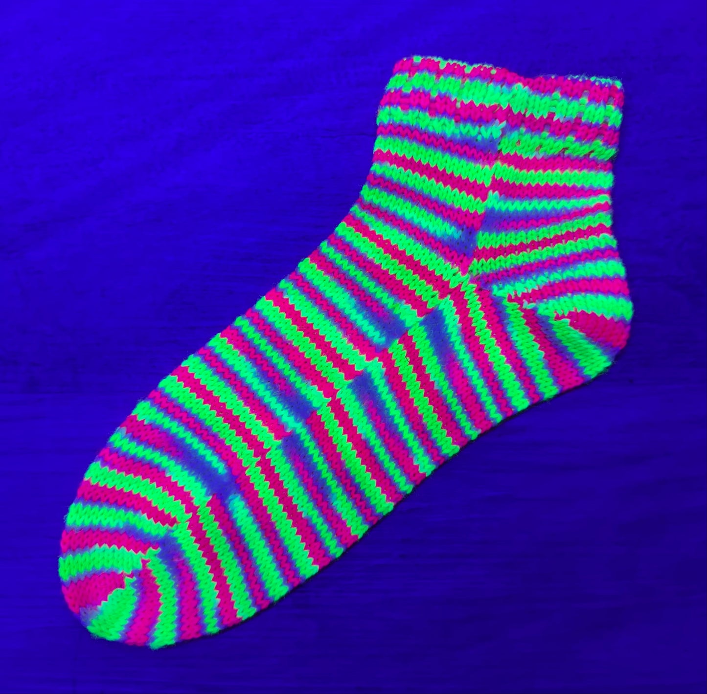 Neon striped sock on a purple background