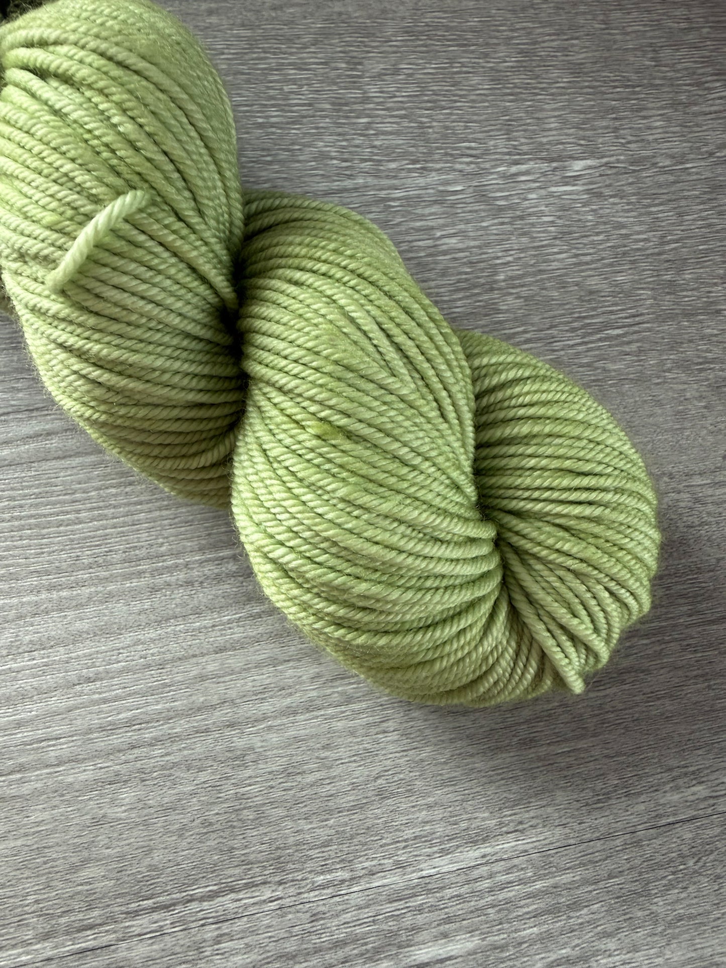 Vibrant lime green "Too Many Margaritas" hand-dyed ethically sourced merino wool yarn skein.