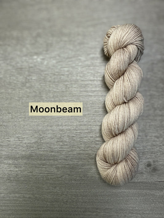 Skein of ethically sourced Moonbeam hand-dyed merino wool and nylon fingering weight yarn.