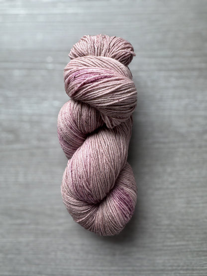 Pink skein of yarn on a gray background
