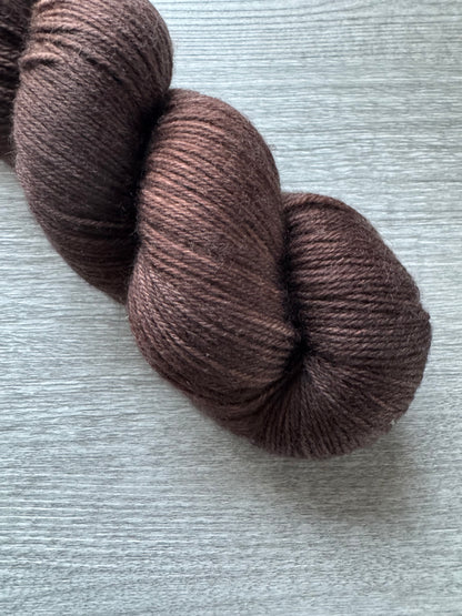 Brown skein of yarn on a light gray background
