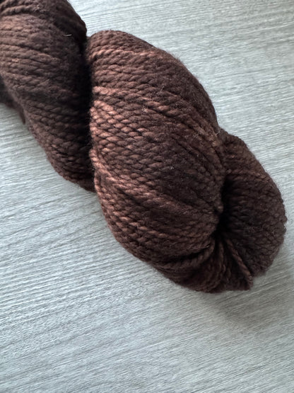 Brown skein of yarn on a light gray background