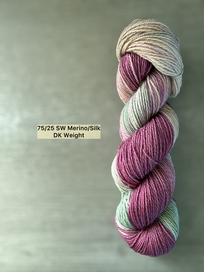 Ethically sourced hand-dyed merino/silk yarn in plum, ivory, and sage green, DK weight.