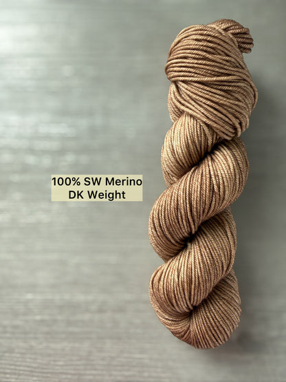 Ethically sourced "Lake House" brown SW Merino DK weight yarn skein, showcasing soft and medium tones.