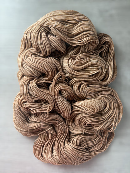 Hand-dyed "Lake House" ethically sourced merino wool yarn in soft and medium browns.