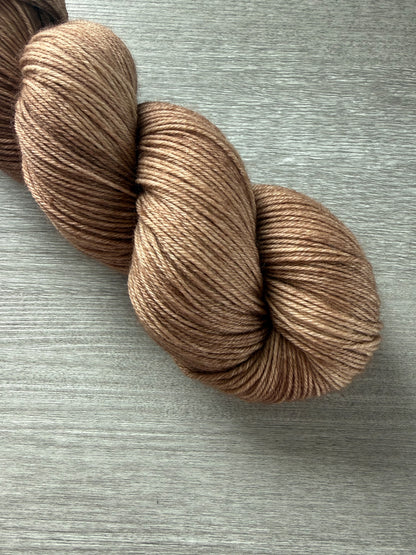 Hand-dyed "Lake House" ethically sourced merino wool yarn in soft and medium browns.