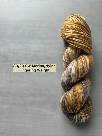 Hand-dyed Mesa merino wool yarn, variegated with beige, charcoal, taupe, and toasted ocher. Ethically sourced.