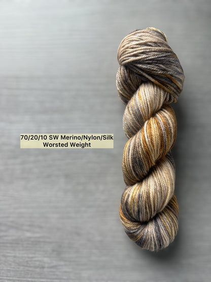 Hand-dyed Mesa worsted weight yarn: ethically sourced merino, nylon, silk blend in beige, charcoal, taupe, and ocher.