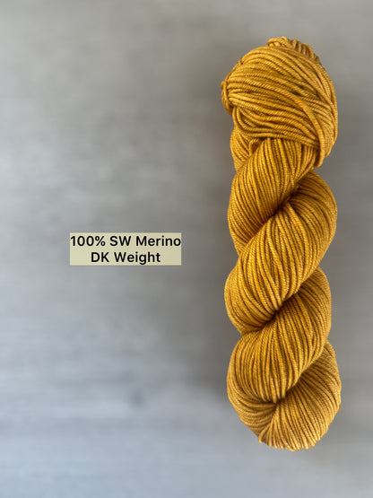 Hand-dyed "None Of Your Beeswax" golden yellow ethically sourced merino wool DK weight yarn.