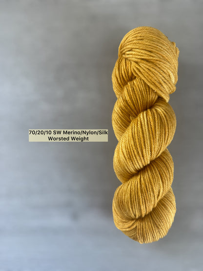 Hand-dyed "None Of Your Beeswax" golden yellow merino wool blend yarn, worsted weight.