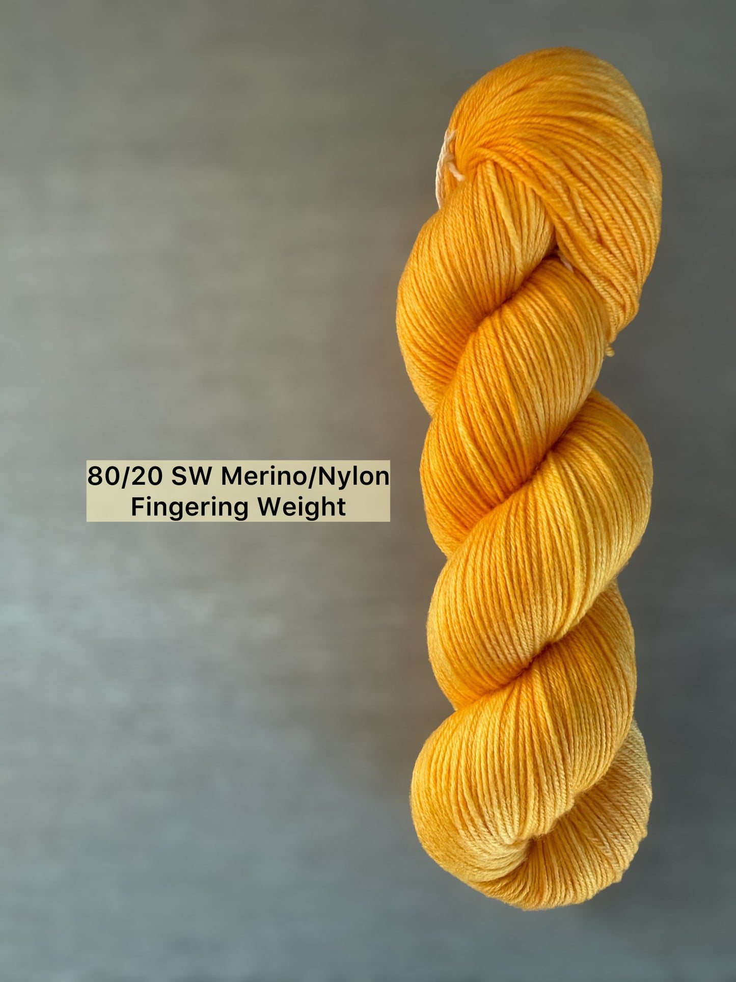 Bright golden yellow Soleil hand-dyed 80/20 SW Merino/Nylon fingering weight yarn skein.