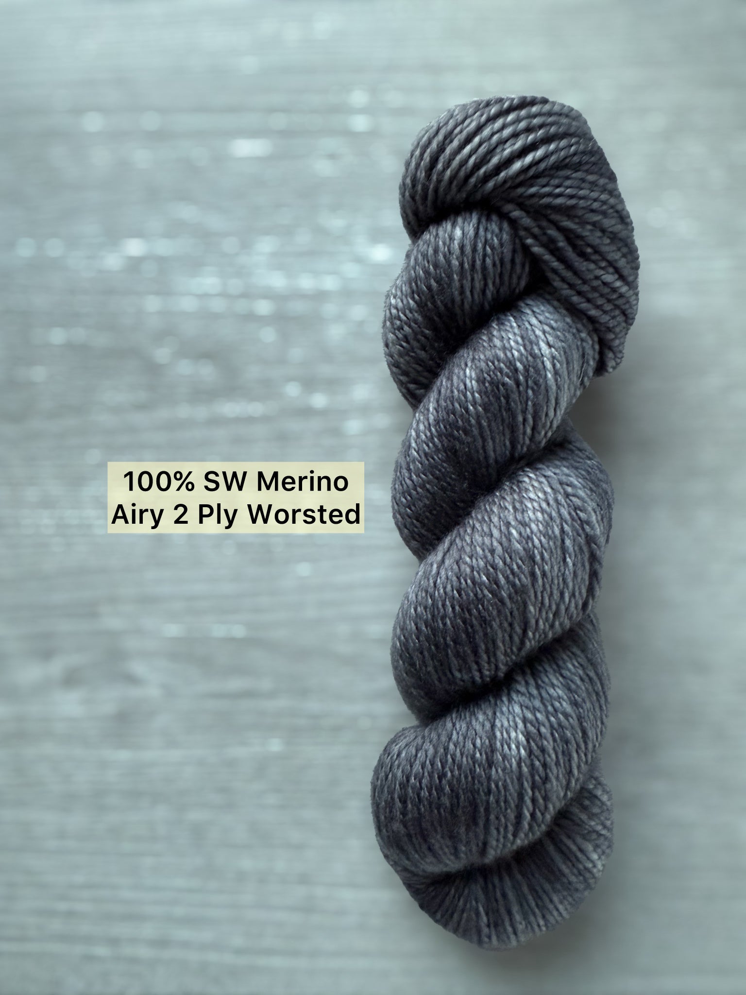 Ethically sourced, hand-dyed dark charcoal merino wool yarn skein, "Soot Yourself" color, Airy 2 Ply Worsted.