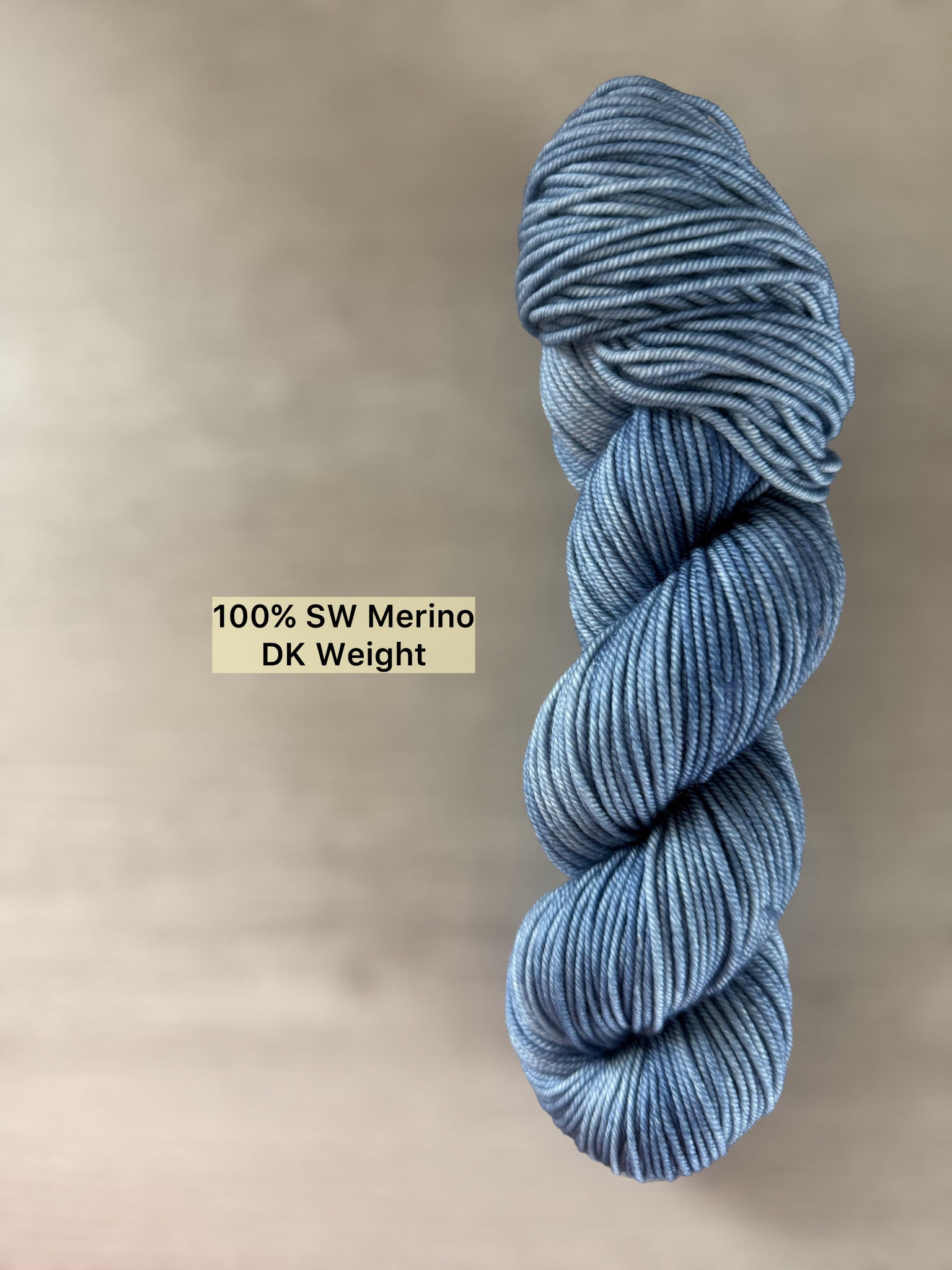 Hand-dyed "West Bay" ethically sourced merino wool yarn in serene blue tonal shades.