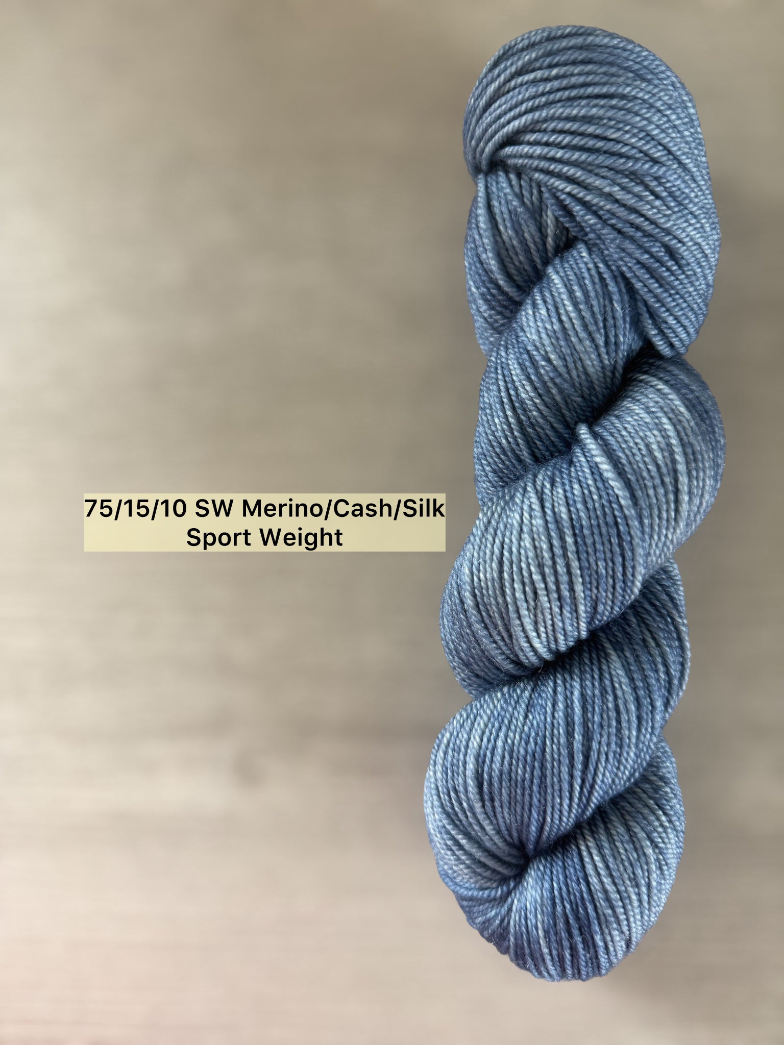 Hand-dyed "The West Bay" ethically sourced merino wool yarn in serene blue tonal shades.
