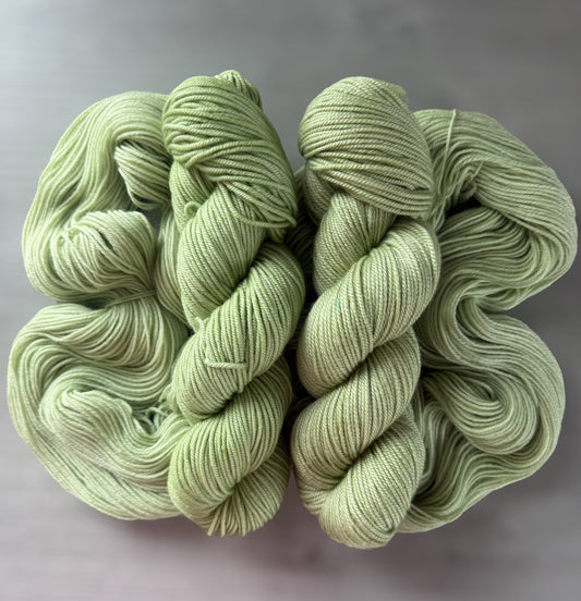Two skeins of "Too Many Margaritas" vibrant lime green hand-dyed ethically sourced merino wool yarn.