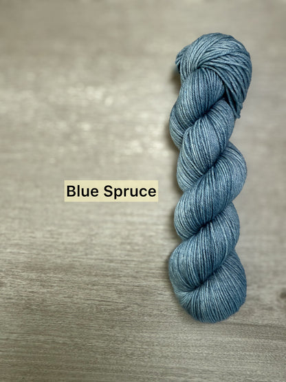 Ethically sourced Blue Spruce hand-dyed merino wool and nylon fingering weight yarn skein.