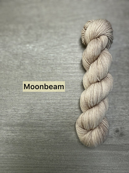 Skein of ethically sourced Moonbeam hand-dyed merino wool and nylon fingering weight yarn.