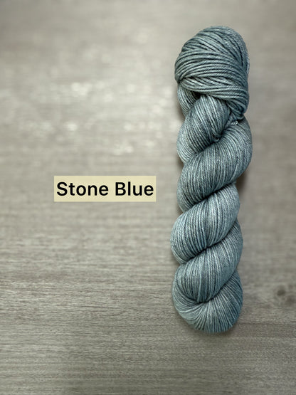 Ethically sourced "Stone Blue" hand-dyed merino wool and nylon fingering weight sock yarn skein.